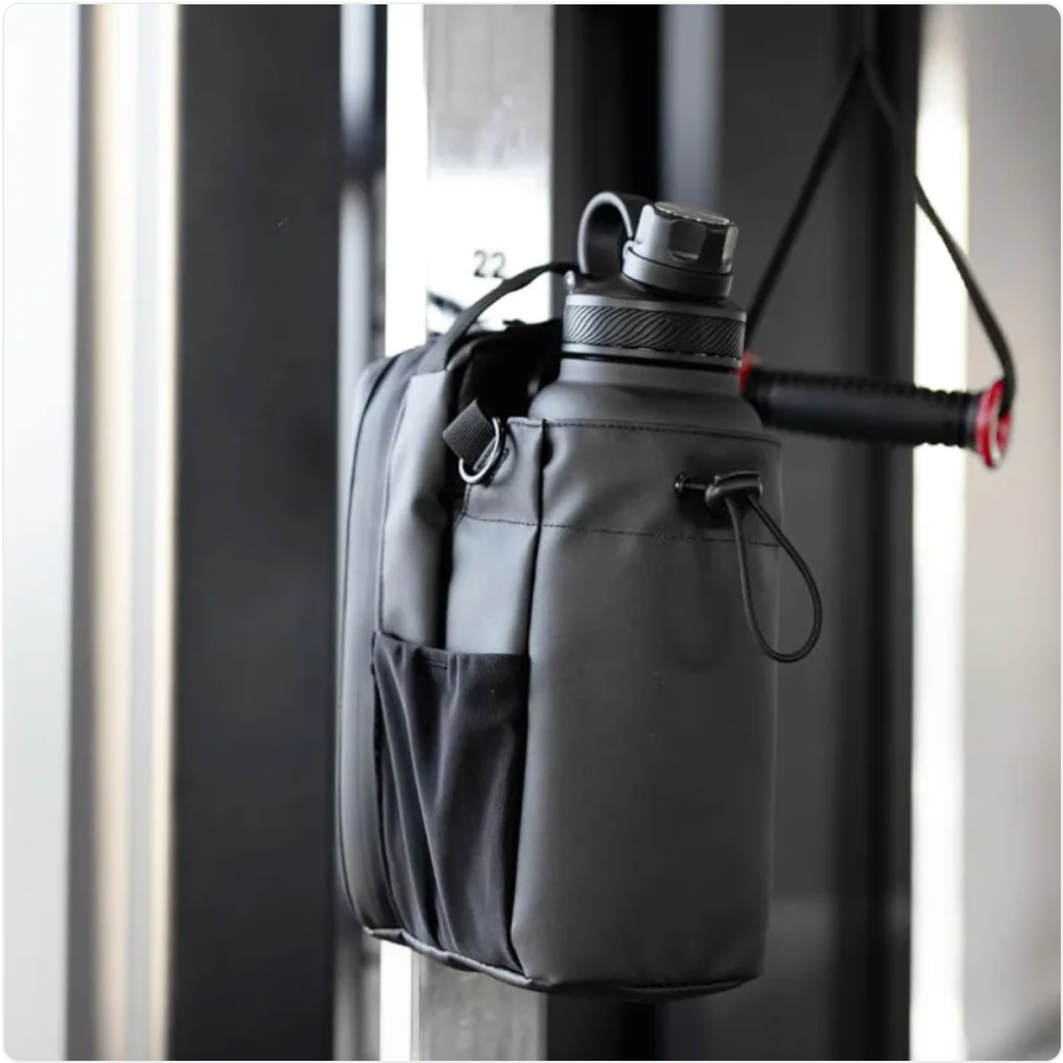 ShakeMix Gym Bag with external shaker bottle holder, black fitness bag with spacious interior and durable design.